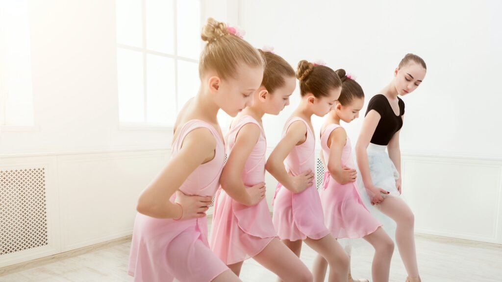 Teacher helping her students during dance class
